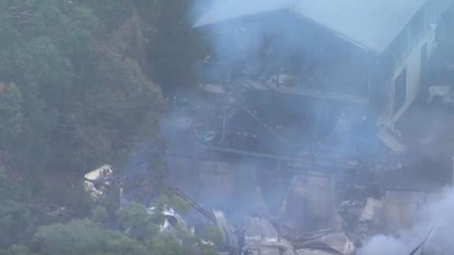 Emergency services are combing through the ruins of Russell Island homes after they were destroyed by fire on Sunday. Picture: Supplied / ABC