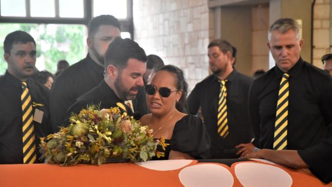 Chansey Paech MLA alongside other pallbearers dressed with black and yellow ties comforted Mr Costa’s daughter Jaunnita at the St Mary’s Cathedral service. Picture: Sierra Haigh