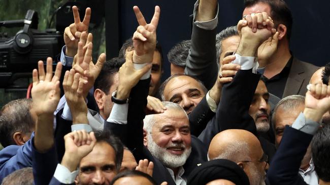 Ismael Haniyeh (C) and other officials, flash the victory sign during a swearing in ceremony Iran’s new president Masoud Pezeshkian. Picture: AFP.