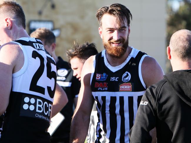 Charlie Dixon speaks with coaches at quarter time during Port Adelaide’s 45-point win over Norwood at Alberton Oval on Sunday. Picture: AAP/Emma Brasier