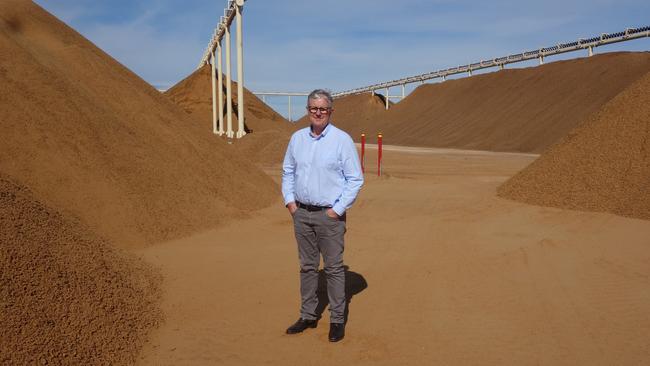 Mr Thompson with almond hull and shell that will be turned into liquid fertiliser and compost at Select Harvests' Carina West processing plant.