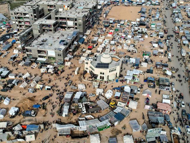 This aerial view shows the makeshift tent camps housing Palestinians seeking refuge in open areas around the Raed al-Attar Mosque in Rafah in the southern Gaza Strip near the Egyptian border. Picture: AFP