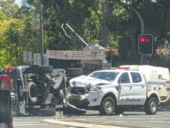 A car has flipped on its side after a major collision with a police car in Sydney’s north-west. Emergency services are responding to a crash on the corner of Cressy Rd and Victoria Rd in Ryde about 12.30pm on Monday. Picture: Supplied.