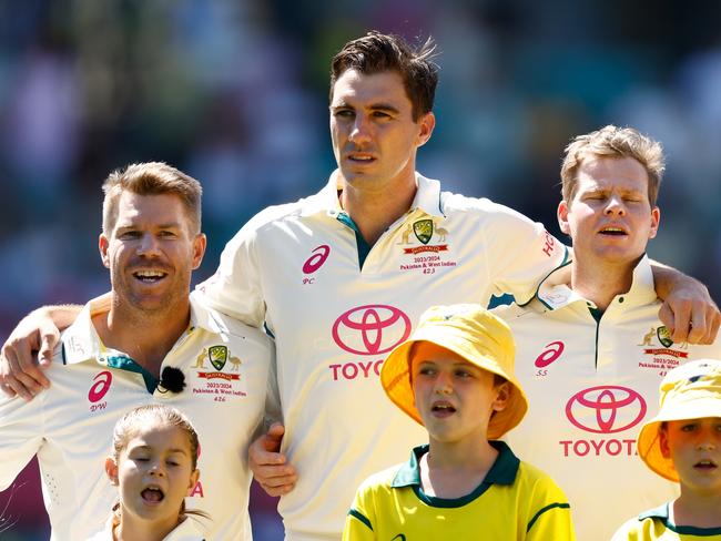 SYDNEY, AUSTRALIA - JANUARY 03: David Warner, Pat Cummins, Steve Smith and Travis Head of Australia sign the national anthem prior to the start of play on day one of the Men's Third Test Match in the series between Australia and Pakistan at Sydney Cricket Ground on January 03, 2024 in Sydney, Australia. (Photo by Darrian Traynor/Getty Images)