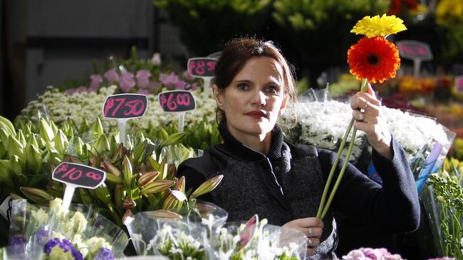 Michael and Sophia Dickson are facing the loss of the business their family has run for more than 20 years, with Prahran Market management refusing to renew their lease when it expires in August. Sophia Dickson with some of her flowers, Picture Yuri Kouzmin