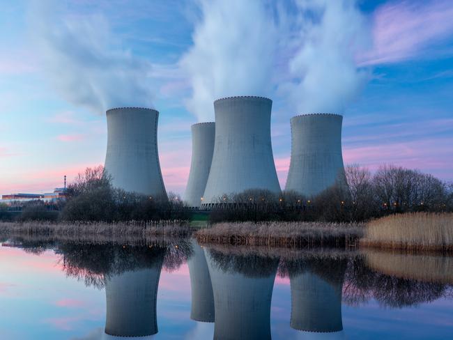 Nuclear power plant after sunset. Dusk landscape with big chimneys.