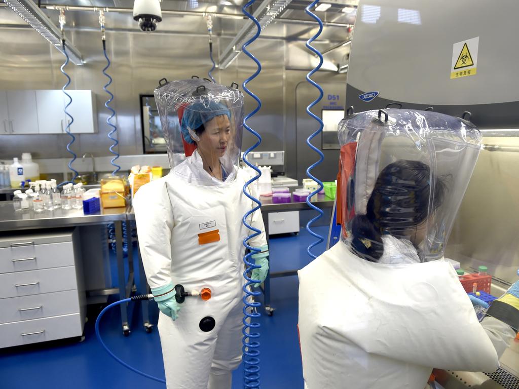 Virologist Shi Zheng-li, nicknamed ‘bat woman’ works with her colleague in the P4 lab of Wuhan Institute of Virology. Picture: Getty Images