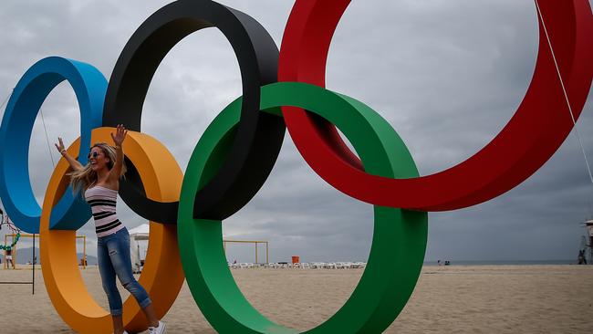 RIO DE JANEIRO, BRAZIL - JULY 21: A woman poses with the Olympic Rings after its inauguration ceremony at the Copacabana Beach ahead 2016 Rio Olympics on July 21, 2016 in Rio de Janeiro, Brazil. (Photo by Buda Mendes/Getty Images)