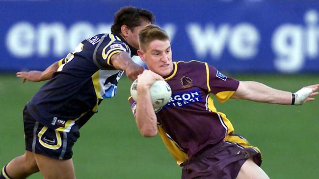 A baby-faced Brent Tate bursts through the Cowboys defence in 2002.