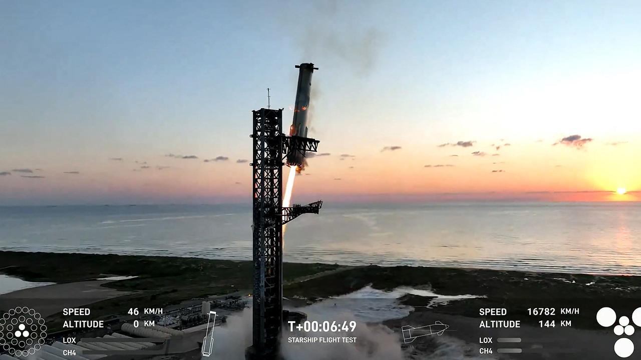 The Starship's Super Heavy Booster being grappled mid-air as it returns to the launch pad at Starbase near Boca Chica, Texas, on October 13, 2024, during the Starship Flight 5 test. Picture: SPACEX / AFP.