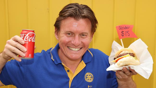 Geelong East Rotary member Laurent Franklin with a feed for under $15 - a burger with the lot for $9.50 and a can of drink for $2.50 at the Geelong Show. Picture: Alison Wynd