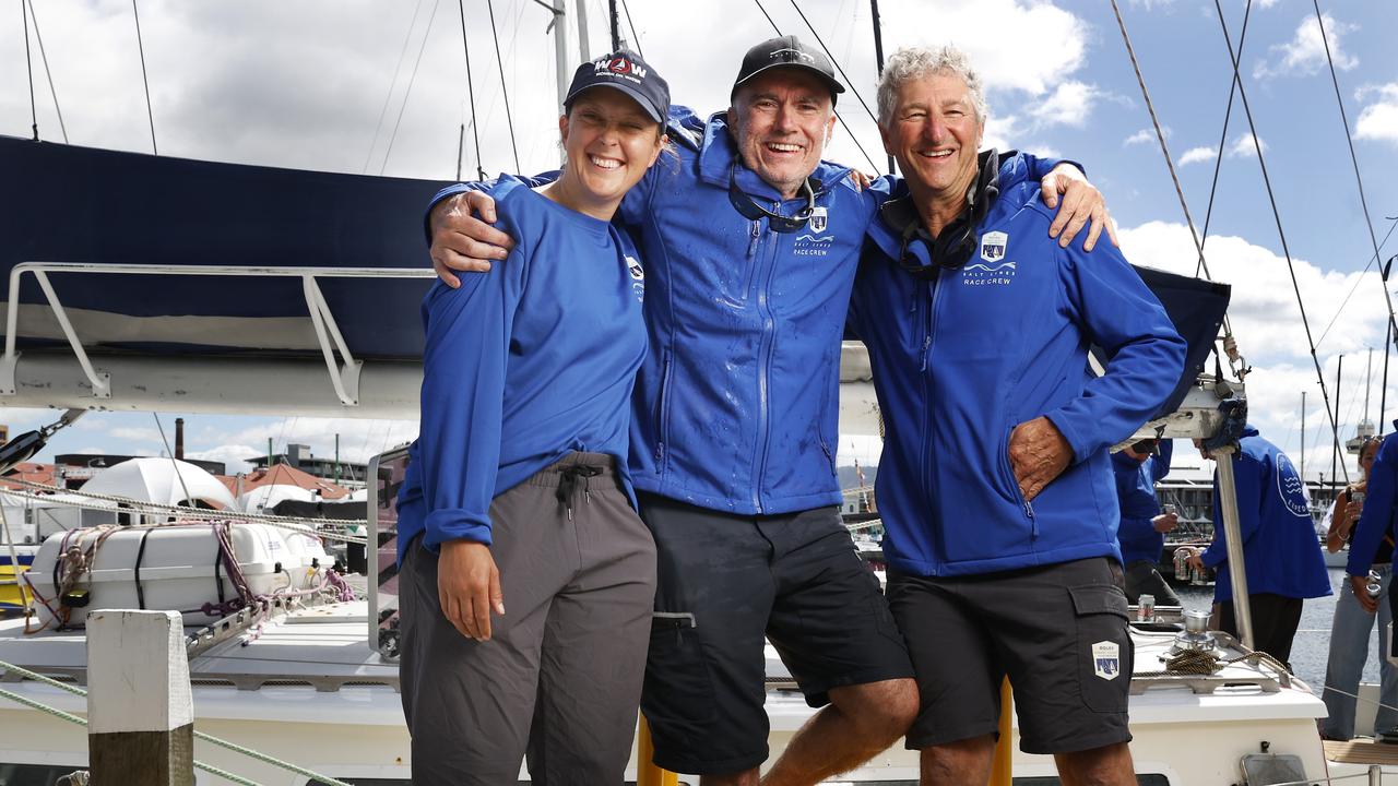 First mate Jess Hix, skipper Murray Stewart, and navigator Rick Stern celebrates as Salt Lines becomes the final boat to finish the 2024 Sydney to Hobart on Wednesday morning. Picture: Nikki Davis-Jones