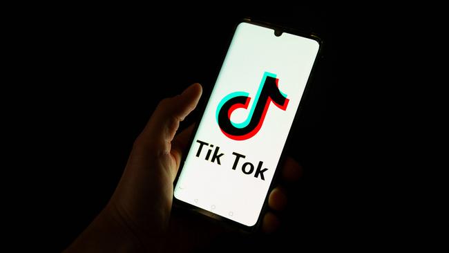 (FILES) This photograph taken on April 19, 2024 shows a man holding a smartphone displaying the logo of Chinese social media platform Tiktok in an office in Paris. TikTok faces an imminent shutdown in the United States after Congress passed a law last year forcing its Chinses owner ByteDance to either sell the platform or close it by this January 19, 2025. The US Supreme Court is expected to rule this week on TikTok's challenge to the law. (Photo by Antonin UTZ / AFP)