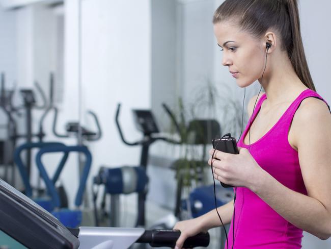 FEELING GREAT - APRIL, 6TH 2015. Fitness Woman. Woman runs on a treadmill, exercise in the sport club