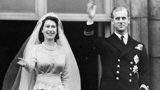 Princess Elizabeth and Prince Philip, Duke of Edinburgh waving to a crowd from the balcony of Buckingham Palace, London shortly after their wedding at Westminster Abbey. Picture: Getty Images.