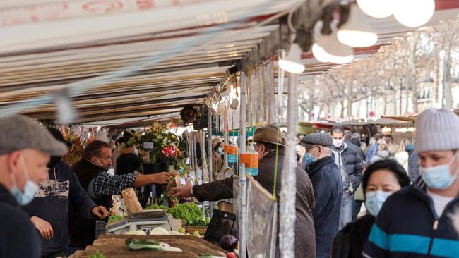 A market stand protected by plastic sheets in Paris. Picture: AFP