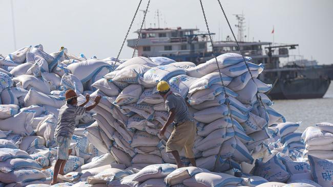 Workers transferring products made with soybeans imported from Brazil at a port in Nantong in China's eastern Jiangsu province. Picture: AFP