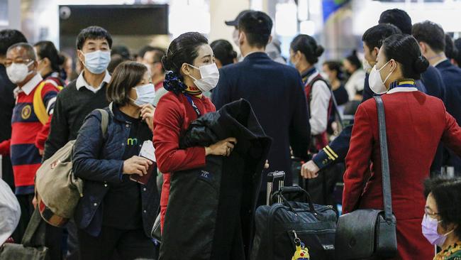 Flight attendants wear masks at Melbourne Airport. Picture: Ian Currie