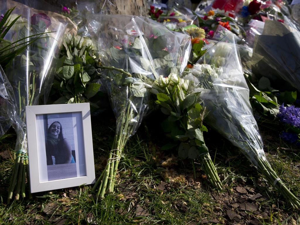 The picture of one of the three victims sits amid flowers as mourners pay their respect at the site of a shooting incident in a tram in Utrecht. Picture: AP