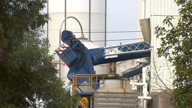 The crane, owned by Misz Pty Ltd, topped onto the Martogg factory on Frankston-Dandenong Rd in Dandenong South. Picture: 9News