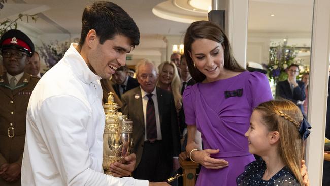 Carlos Alcaraz, with<a capiid="a1f80ea0c3691c5e553da83fec264a44" class="capi-link"> the Princess of Wales</a>, shakes hands with Princess Charlotte in the Clubhouse following his victory. Picture: AELTC/Andrew Parsons