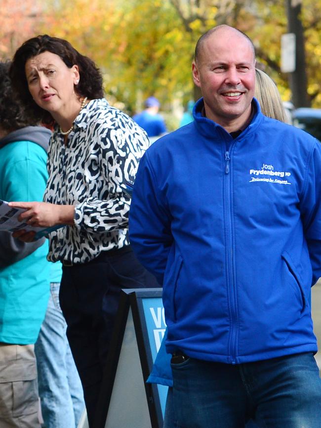 Treasurer Josh Frydenberg visits the pre-polling booth in Hawthorn, Melbourne, and Independent candidate Monique Ryan behind. Picture: Nicki Connolly