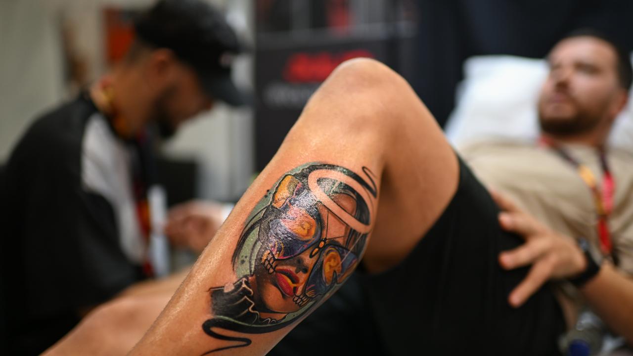 A man reveals the artwork on his leg. Picture: Dan Peled / NewsWire