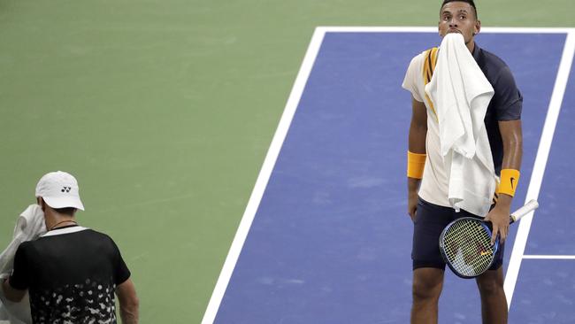 Nick Kyrgios, right, and Radu Albot, of Moldova, return to their chairs during a break in play. Picture: Julio Cortez/AP