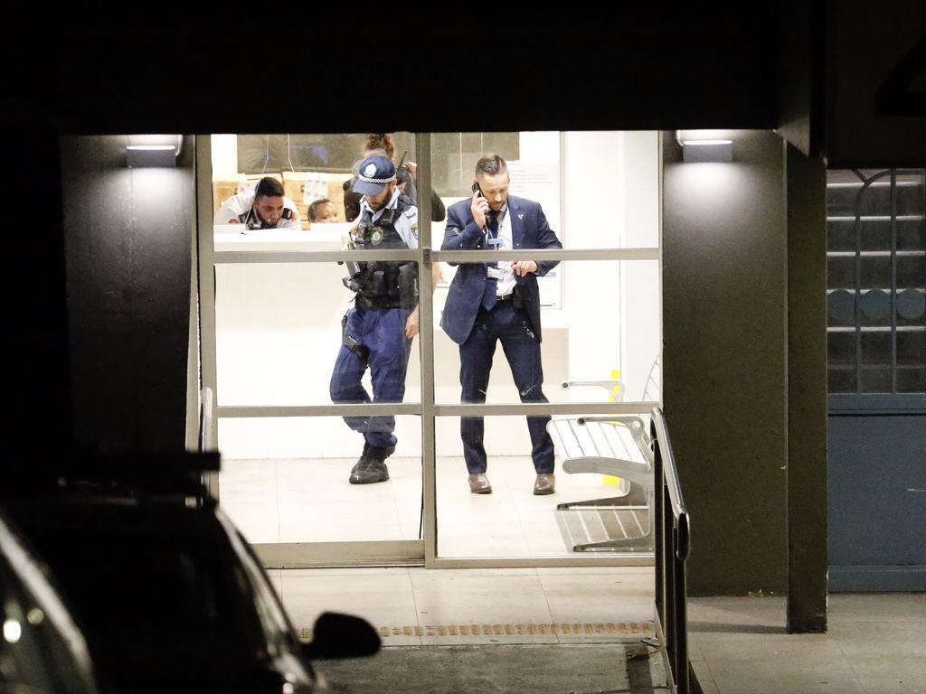 Detectives and police in the foyer of the housing commission building where David Bradshaw was fatally stabbed. Picture: Steve Tyson