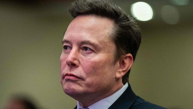 TOPSHOT - Elon Musk listens as US President-elect Donald Trump speaks during a meeting with House Republicans at the Hyatt Regency hotel in Washington, DC on November 13, 2024. (Photo by Allison ROBBERT / POOL / AFP)