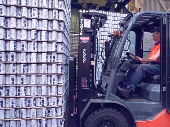 Thousands of cans of water are stacked ready to be sent to disaster areas.