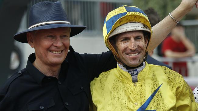 Australian jockey Hugh Bowman, right, poses with trainer John Moore after riding Hong Kong horse " Werther " to win the Audemars Piguet QEII Cup at the Sha Tin race course in Hong Kong Sunday, April 24, 2016. (AP Photo/Vincent Yu)