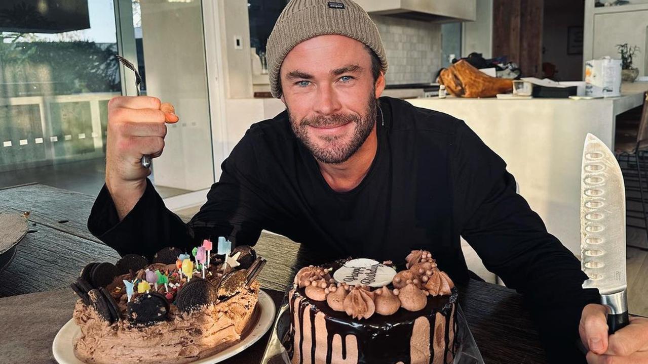 Actor Chris Hemsworth with a $29 Woolworths drip cake (right) for his birthday.