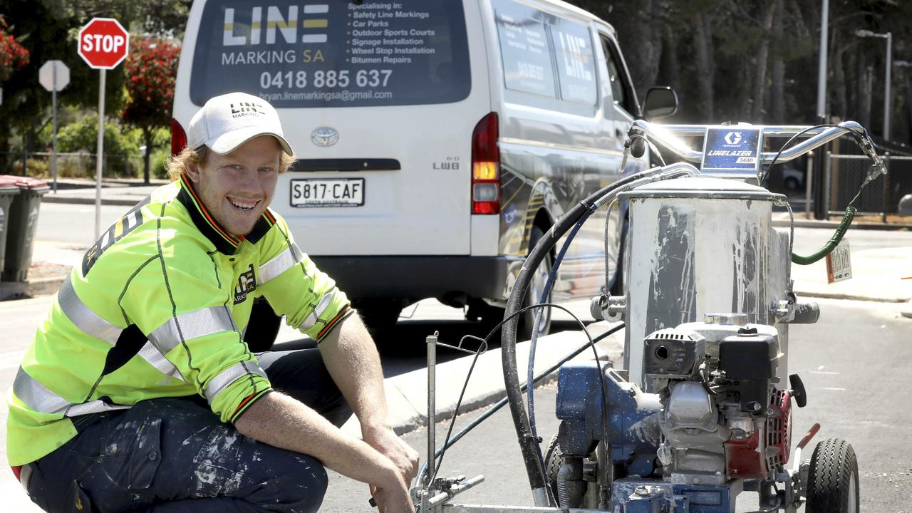 Josh Scott starred for Glenelg in the SANFL grand final. He works as a line marker and is pictured working on a bike lane in Edwardstown. 11 October 2019. Picture Dean Martin