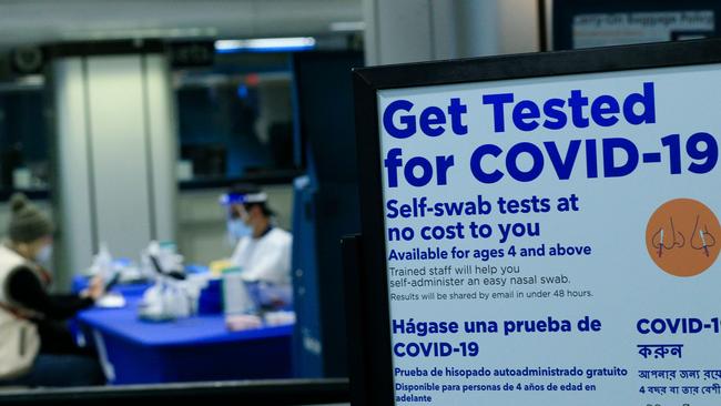 A woman gets a self coronavirus test at a free walk-up testing site inside Penn Station in New York. Picture: AFP