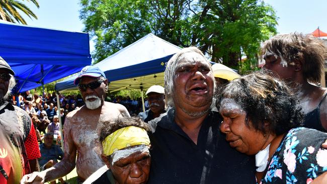 Grandmother of Kumanjayi Walker Anna Dixon from Kintore (centre, left) and the second grandmother of Kumanjayi Walker, Margaret Brown of Yuendumu (centre) and an unidentified mourner, and artist Robin Granites (background, second from left) at a Protest march over his death, Alice Springs. Picture: Chloe Erlich