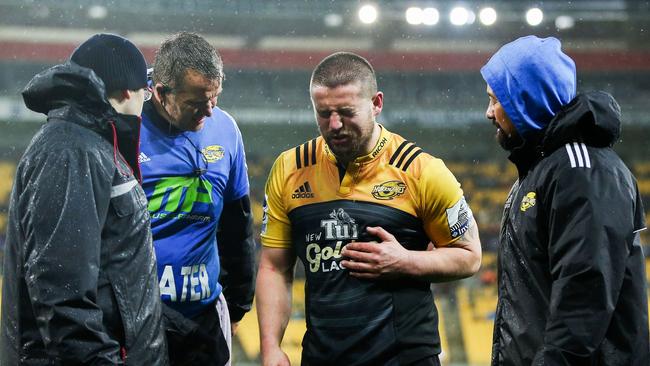 Captain Dane Coles of the Hurricanes leaves the field with an injury.
