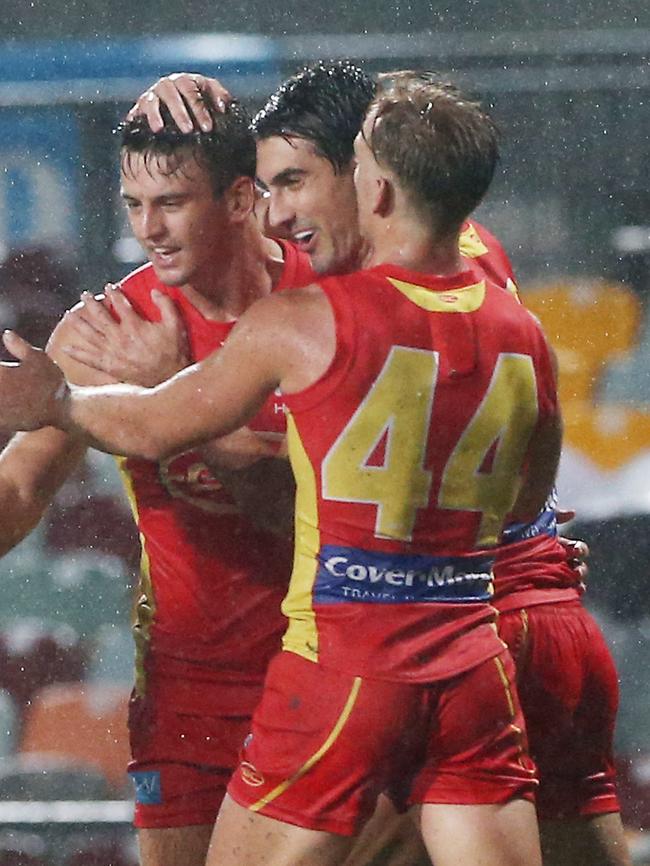 Action from the AFL match between the Gold Coast Suns and the North Melbourne Kangaroos, held at Cazalys Stadium, Cairns. Gold Coast's Nick Holman (centre) is congratulated by his teammates after kicking a goal. PICTURE: BRENDAN RADKE.