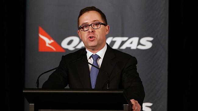 Tough day at the office ... Qantas chief executive Alan Joyce announces a first-half loss of $235 million during a press conference in Sydney.