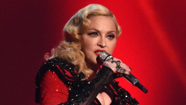 FILE - In this Feb. 8, 2015 file photo, Madonna performs at the 57th annual Grammy Awards in Los Angeles. From Madonna to Mariah Carey, more and more acts are looking to platforms like Tinder and Match to promote their music and reach their fans on-the-go. Madonna worked with Grindr, an app for gay men, to launch a campaign for her latest album, while Jason Derulo looked to Tinder to debut a music video. (Photo by John Shearer/Invision/AP, File)