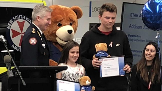 NSW Ambulance Commissioner Dominic Morgan  presented Ayden Jobe and Addison Jobe with their awards for helping to save their mum Jody's life in December 2017. Picture: Lawrence Machado