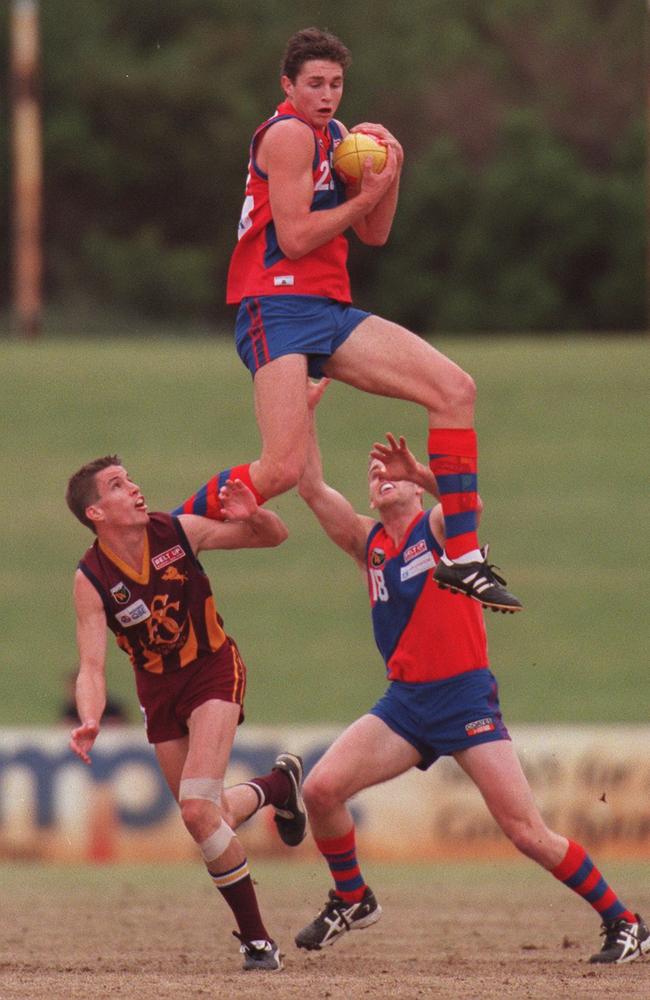 A young Justin Longmuir soars over Nathan O'Connor and teammate Peter Julian for a mark while playing for West Perth in 2000. Picture: Ken Matts