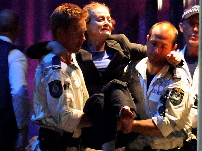 Marcia Mikhael is carried out by police from the Lindt cafe. Picture: Joosep Martinson/Getty Images