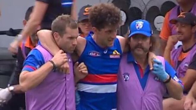 Tom Liberatore is helped from the ground after injuring his knee. Picture: Fox Footy