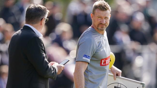 Eddie McGuire chats to coach Nathan Buckley during a training session.