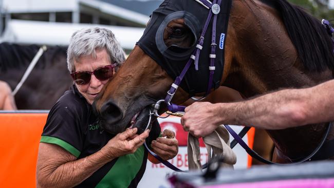 Stable foreman Beverley Gordy congratulates Bullion Wolf after his winning run in the 2021 Cairns Amateurs Cup at Cannon Park.