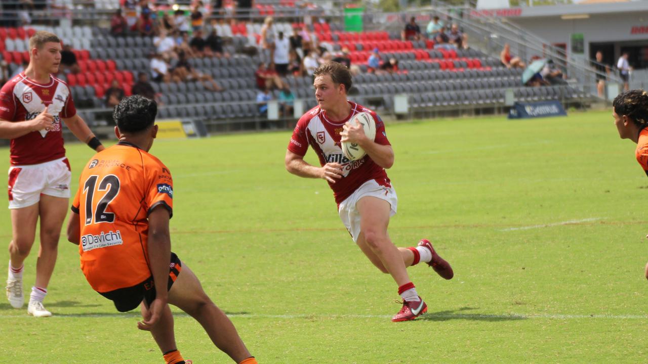 Carter Welfare carries the ball, with Charlie Dickson watching on.