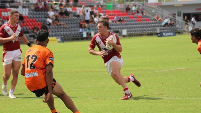 Carter Welfare carries the ball, with Charlie Dickson watching on.