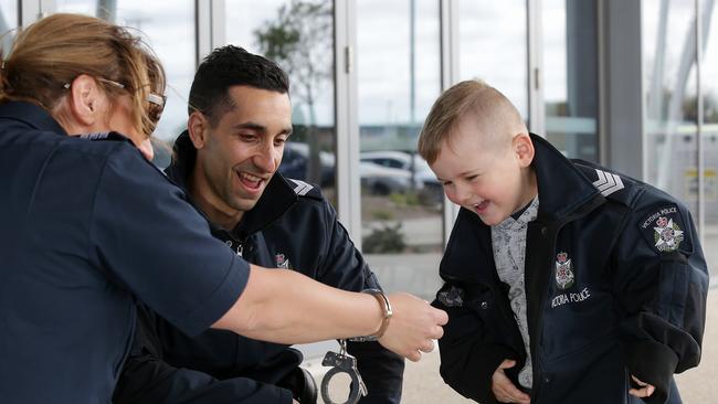 Acting Sergeant Rebecca Amiridis and Senior Constable Andrew Bosco with Ari, 4, outside the Aqua Park. Picture: George Salpigtidis