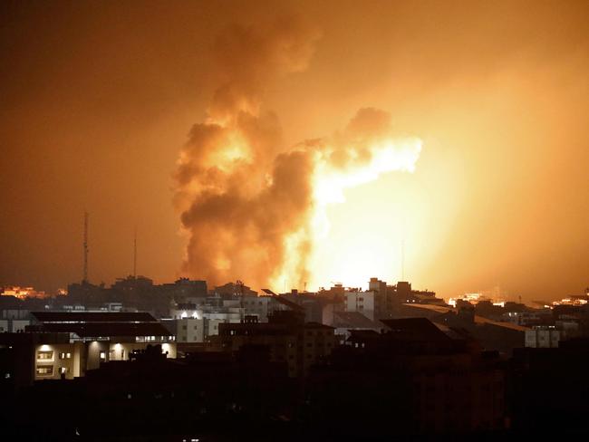 TOPSHOT - Fire and smoke rises above buildings during an Israeli air strike in Gaza City on October 8, 2023. At least 200 Israelis died in a surprise large-scale attack by the Palestinian militant group Hamas on October 7, 2023, the army said, as Prime Minister Benjamin Netanyahu vowed to reduce the group's Gaza hideouts to "rubble". (Photo by EYAD BABA / AFP)